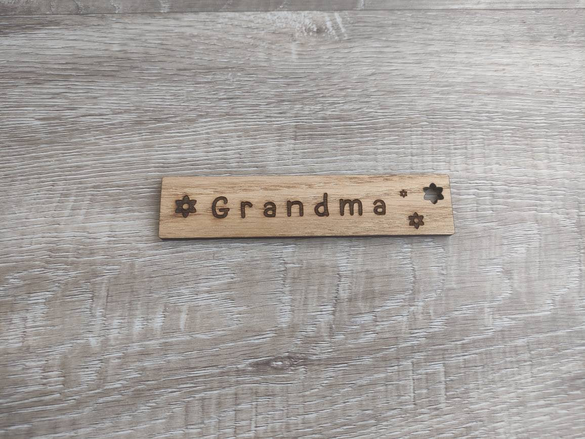 Personalised wooden bookmark engraved with flower designs, featuring two coloured ribbons tied at the top. A thoughtful and custom gift for book lovers, made from high-quality wood.