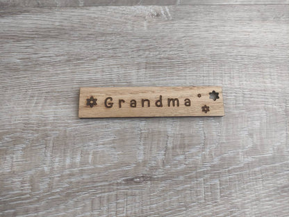 Personalised wooden bookmark engraved with flower designs, featuring two coloured ribbons tied at the top. A thoughtful and custom gift for book lovers, made from high-quality wood.