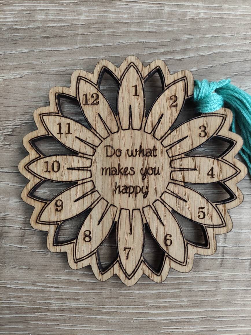 Flower thread holder with "Do What Makes You Happy" engraved, featuring holes for 12 threads.