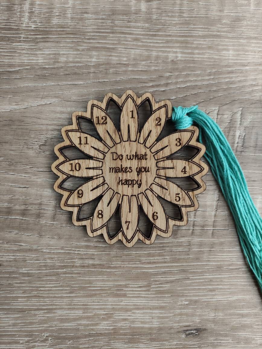 Flower thread holder with "Do What Makes You Happy" engraved, featuring holes for 12 threads.
