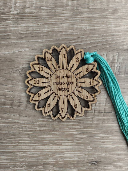 Flower thread holder with "Do What Makes You Happy" engraved, featuring holes for 12 threads.