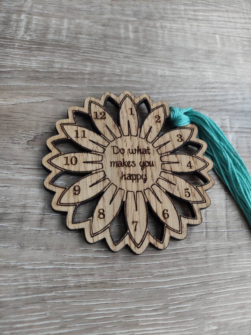 Flower thread holder with "Do What Makes You Happy" engraved, featuring holes for 12 threads.