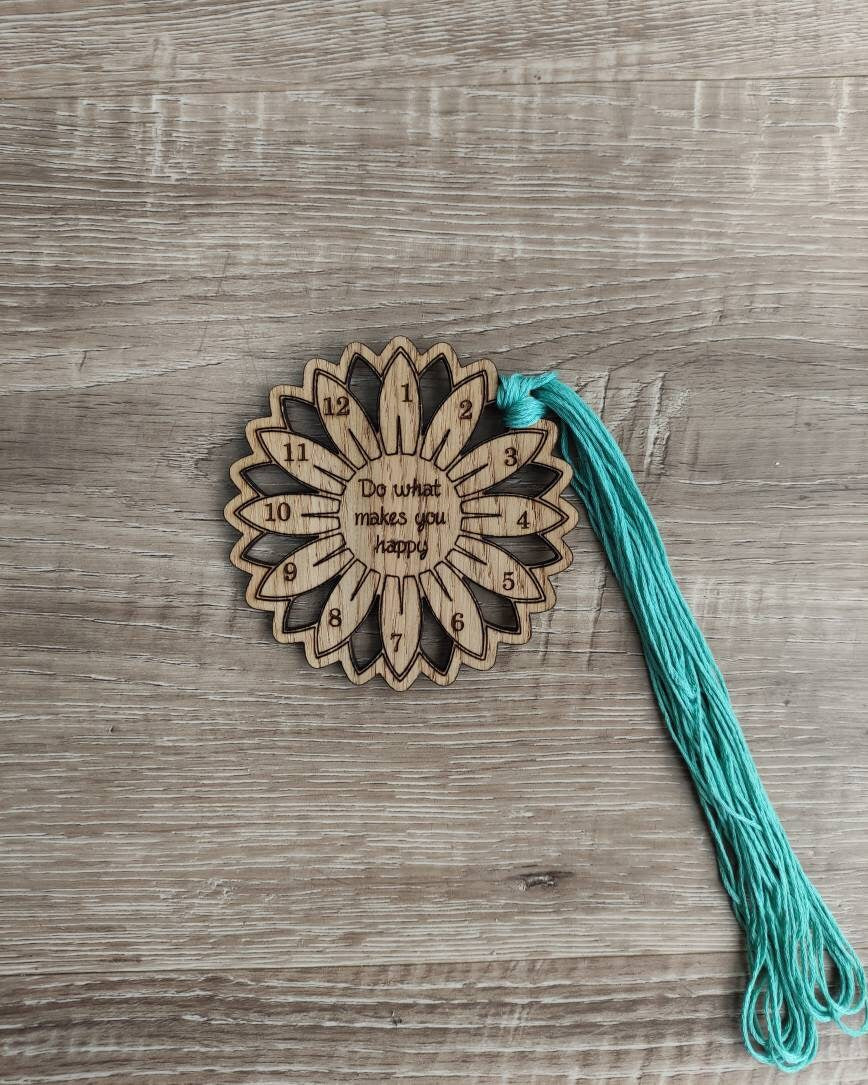 Flower thread holder with "Do What Makes You Happy" engraved, featuring holes for 12 threads.