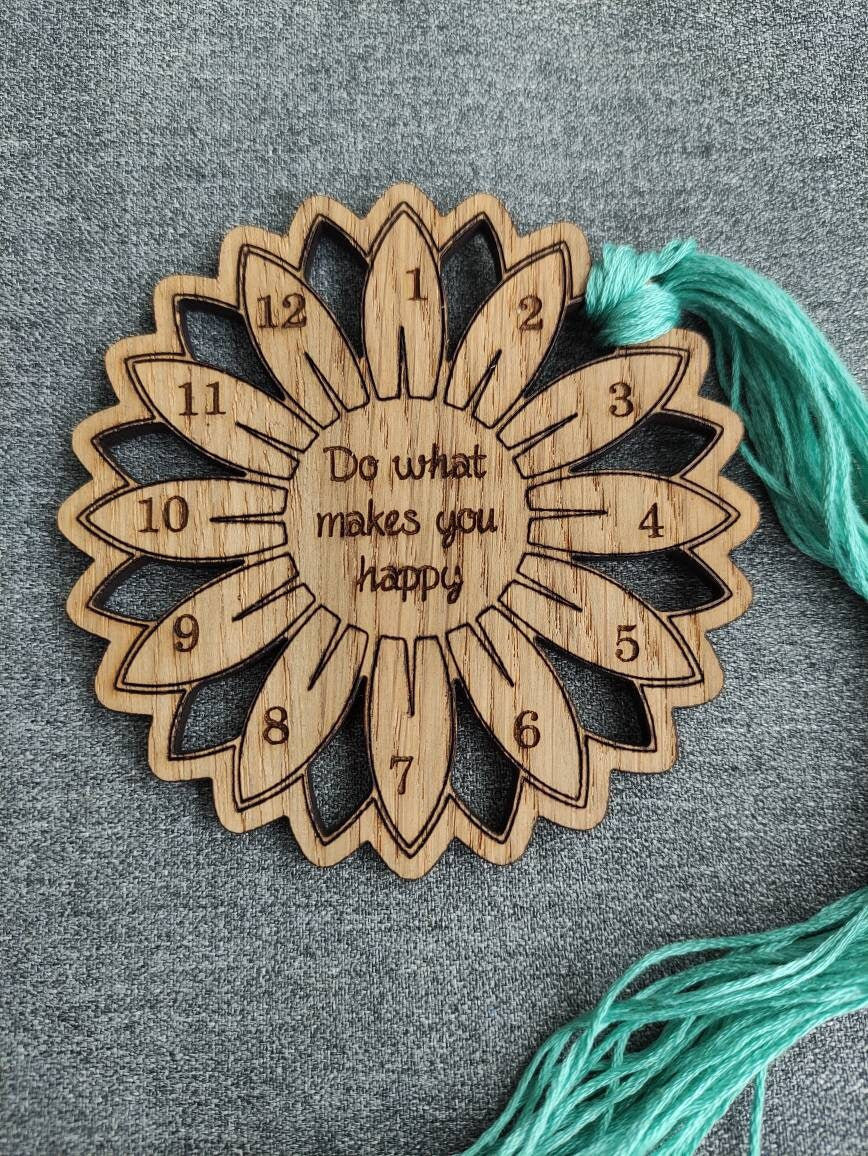 Flower thread holder with "Do What Makes You Happy" engraved, featuring holes for 12 threads.