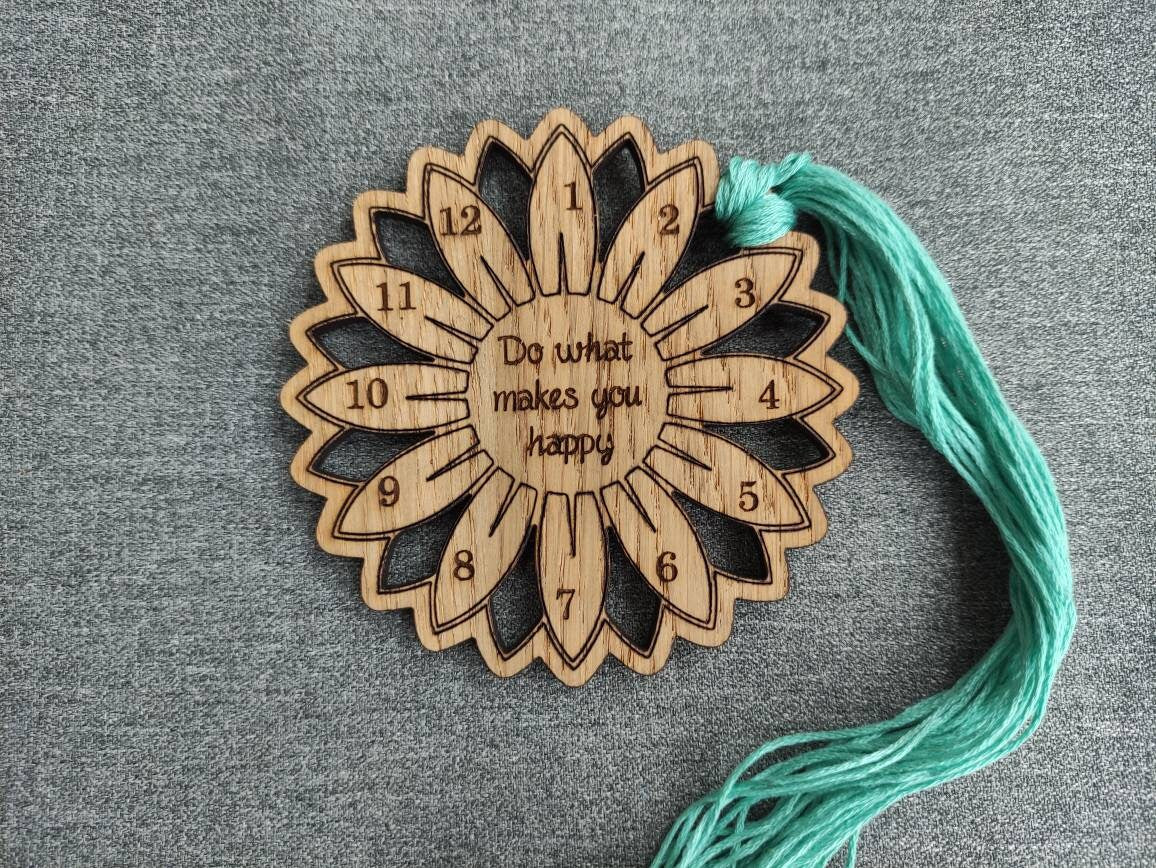 Flower thread holder with "Do What Makes You Happy" engraved, featuring holes for 12 threads.