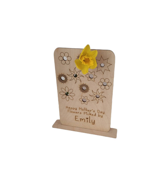 Personalised wooden floral decoration, intricately laser-engraved with flower designs and featuring holes to add your own blooms. 