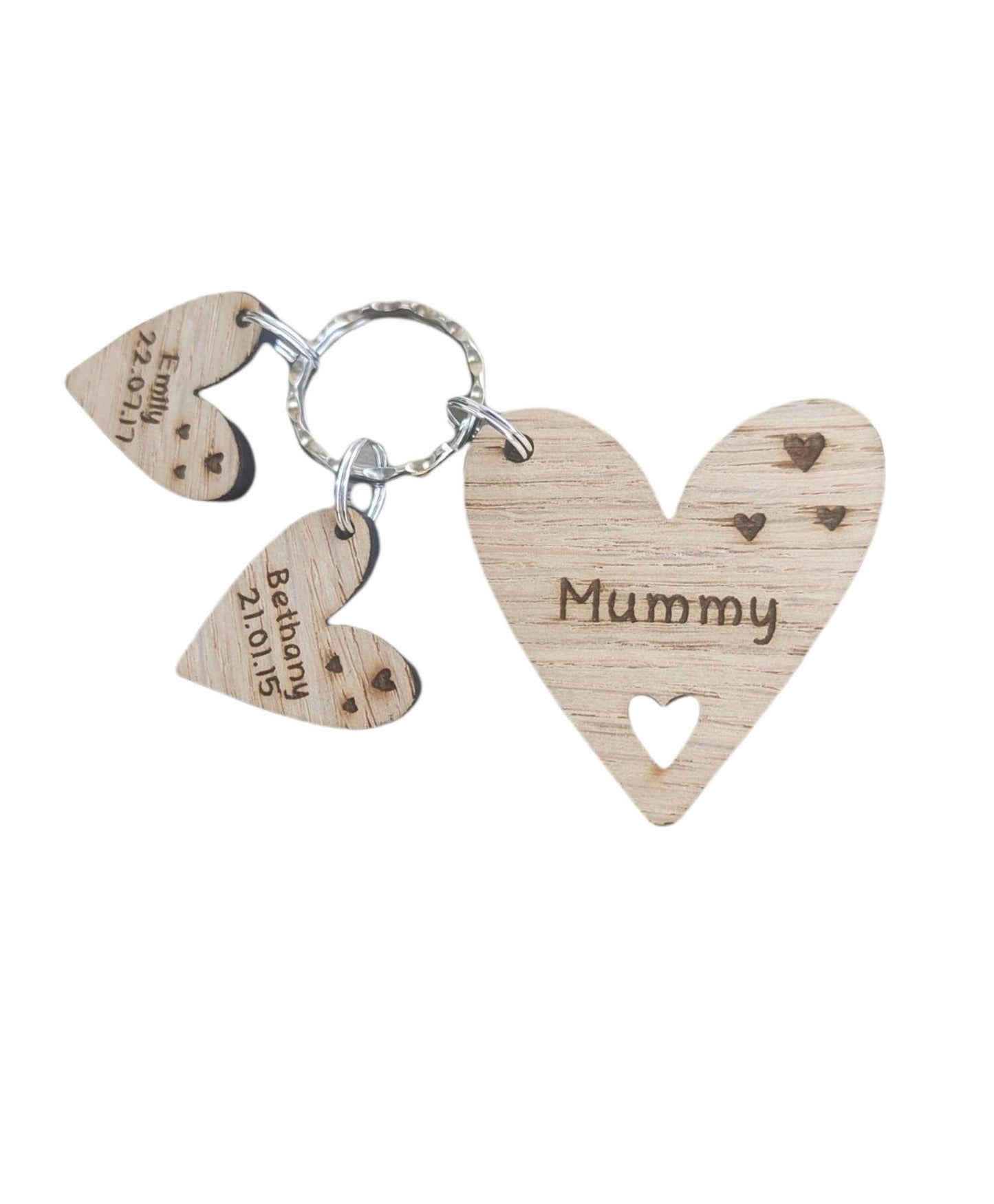 Personalised heart-shaped wooden keyring engraved with "Mummy" and customisable with charms featuring a child’s name and date of birth.