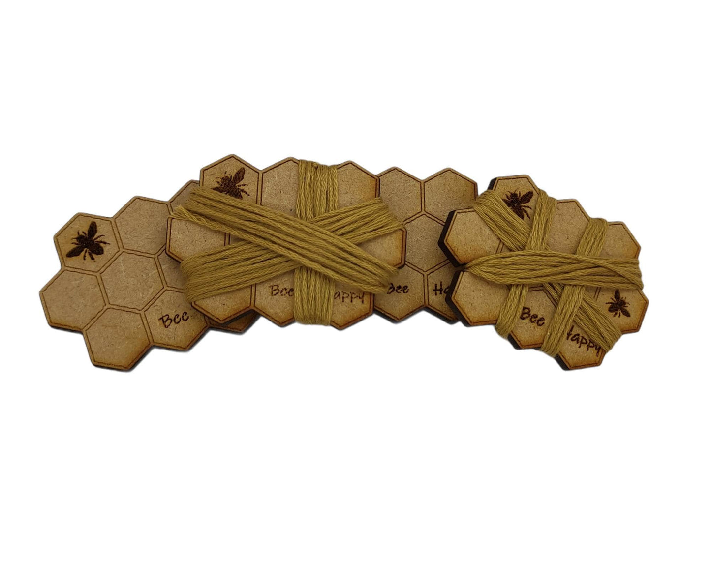 Honeycomb-shaped bobbin for keeping your thread tidy, engraved with bees and 'Bee Happy' design.