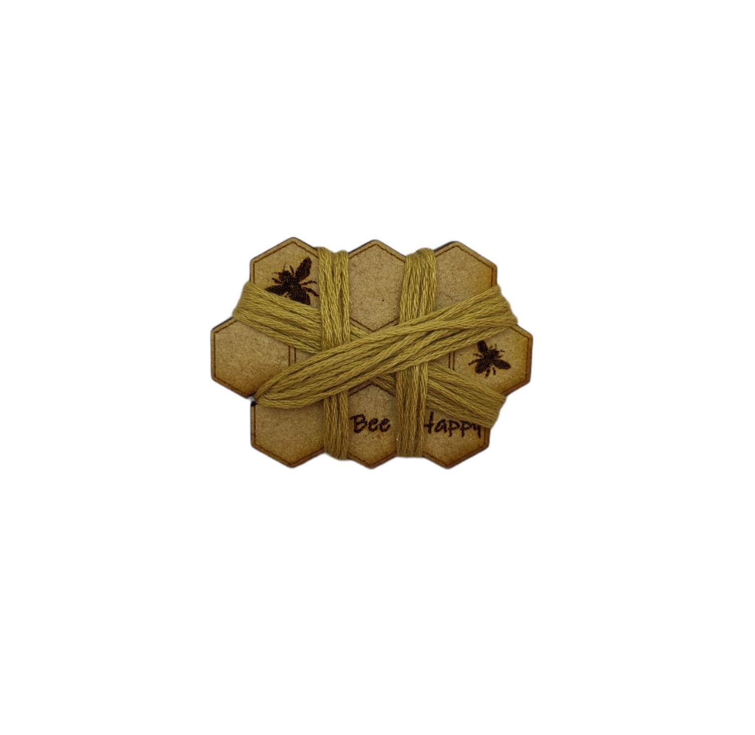 Honeycomb-shaped bobbin for keeping your thread tidy, engraved with bees and 'Bee Happy' design.