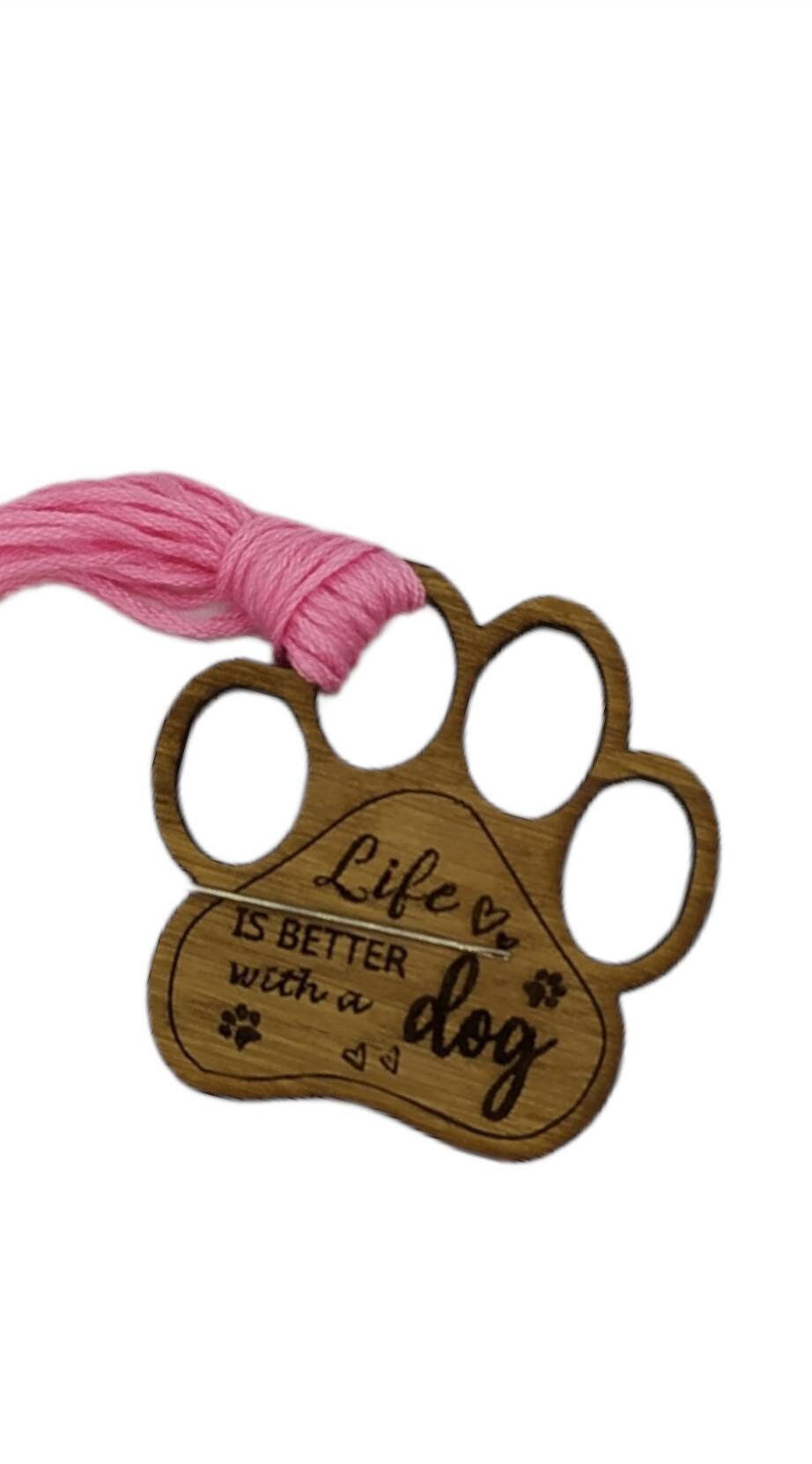 Mini thread holder and needle minder, engraved with the message 'Life is better with a dog'. A practical and heartwarming accessory for any sewing or crafting enthusiast, this dual-purpose item keeps your threads organised and your needles safe.