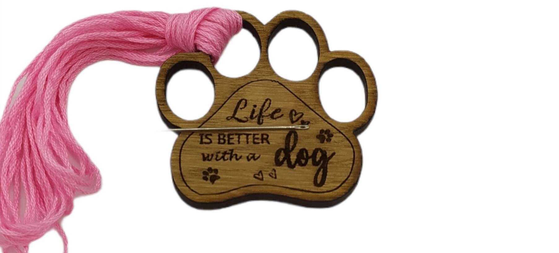 Mini thread holder and needle minder, engraved with the message 'Life is better with a dog'. A practical and heartwarming accessory for any sewing or crafting enthusiast, this dual-purpose item keeps your threads organised and your needles safe.