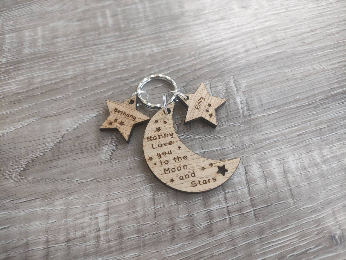 Moon-shaped keyring engraved with "Love you to the Moon & Stars" and star charms engraved with a child's name.