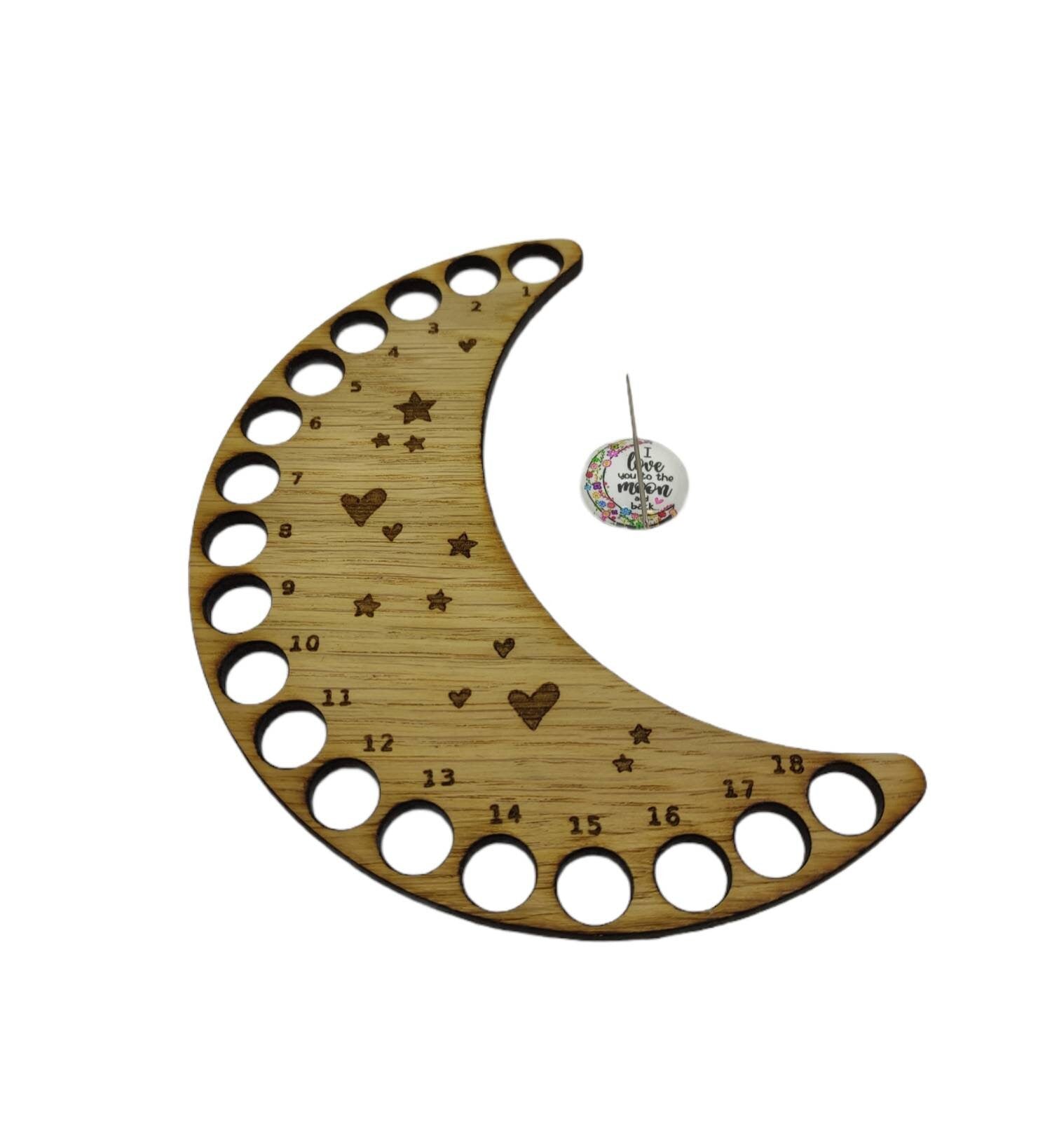 Moon-shaped thread holder with stars and hearts engraved, featuring holes for 18 threads.