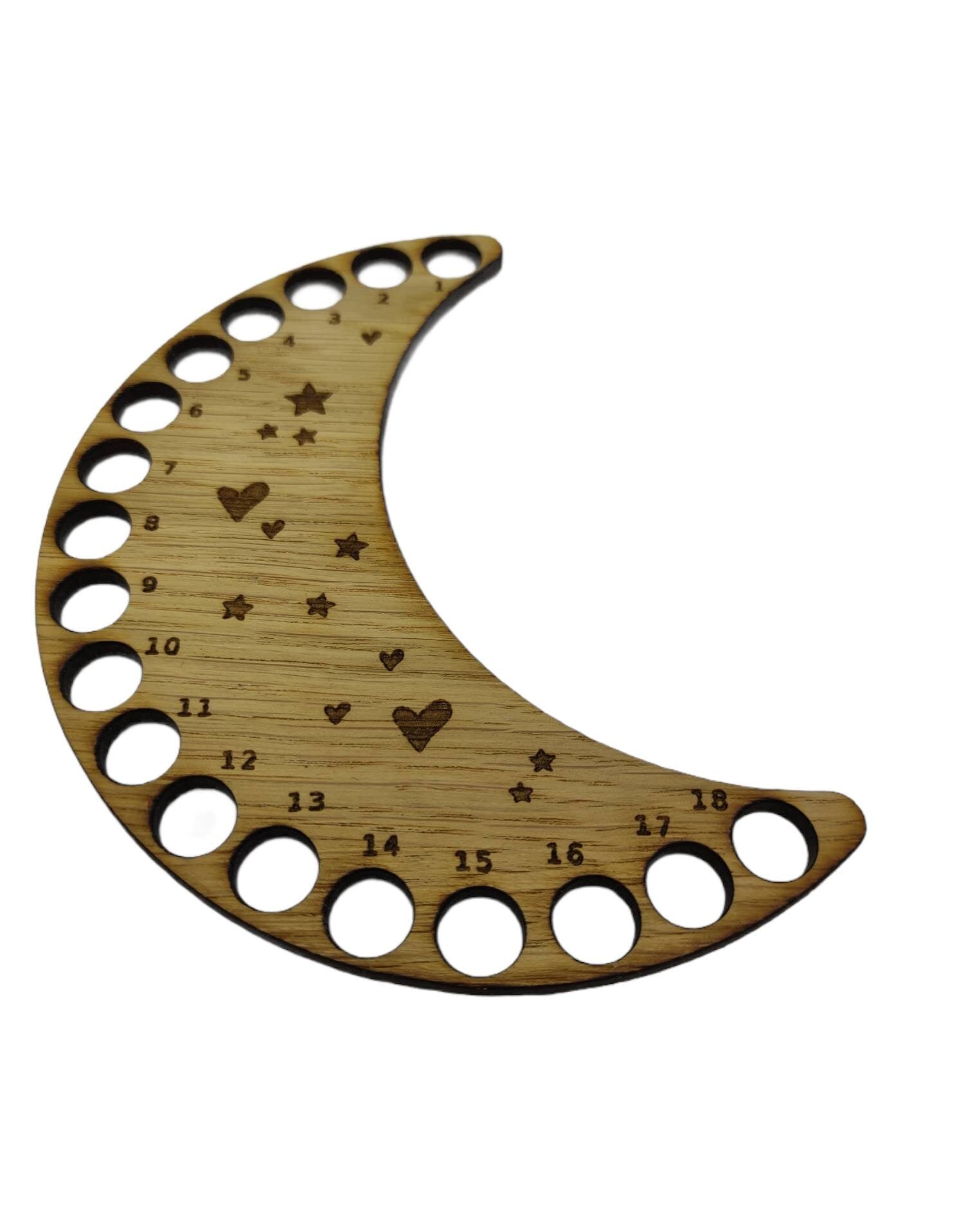 Moon-shaped thread holder with stars and hearts engraved, featuring holes for 18 threads.