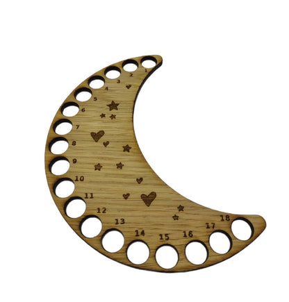 Moon-shaped thread holder with stars and hearts engraved, featuring holes for 18 threads.