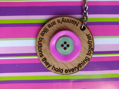 Circle keyring engraved with 'Mum's are like buttons, they hold everything together' around the edge. Two buttons in the middle, with personalised charms featuring children's names and coloured buttons.