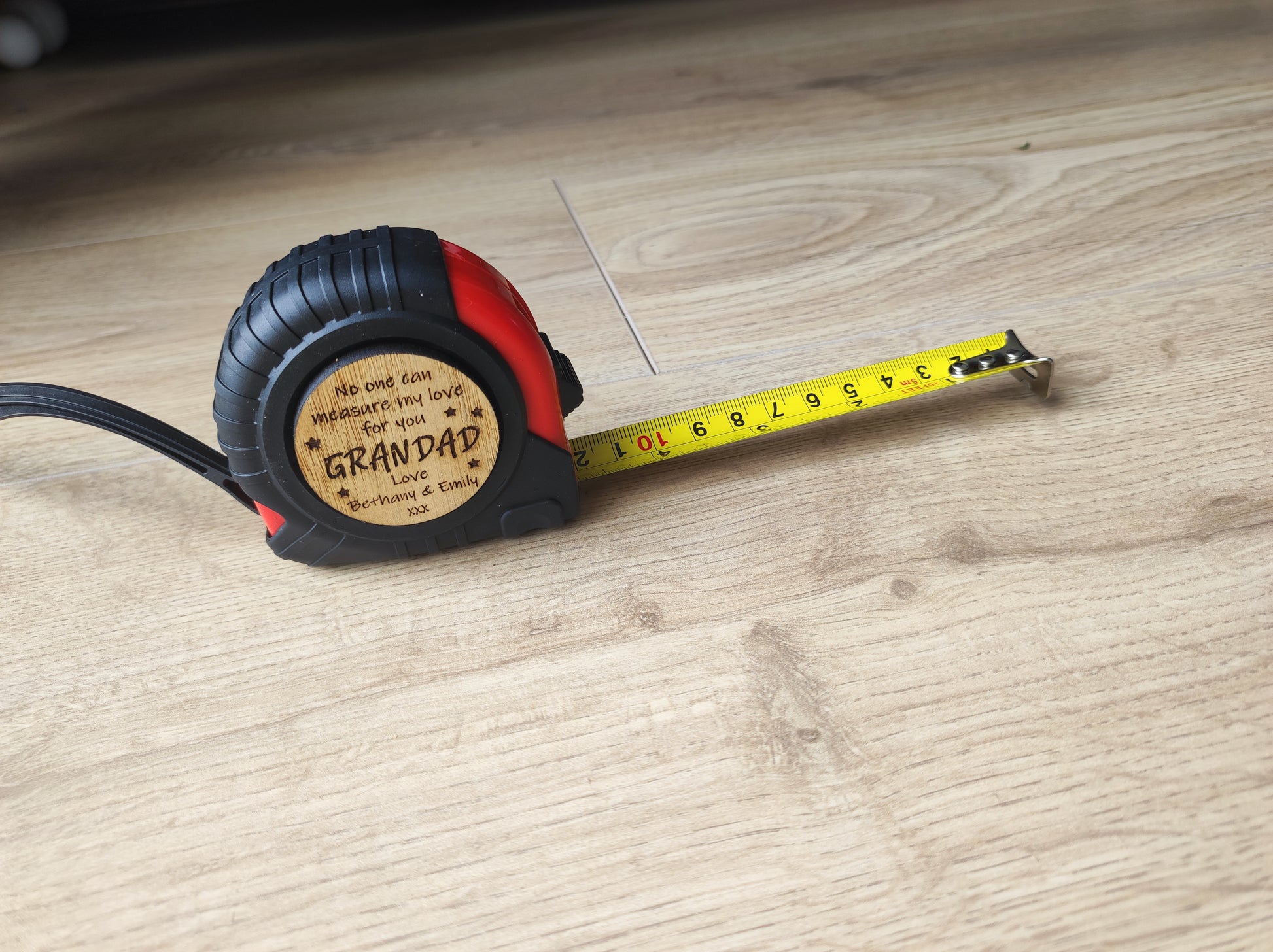 Round tape measure with a playful message: 'No one can measure my love for you.' The disc features a compact, convenient design with a retractable tape, perfect for a thoughtful and unique gift.