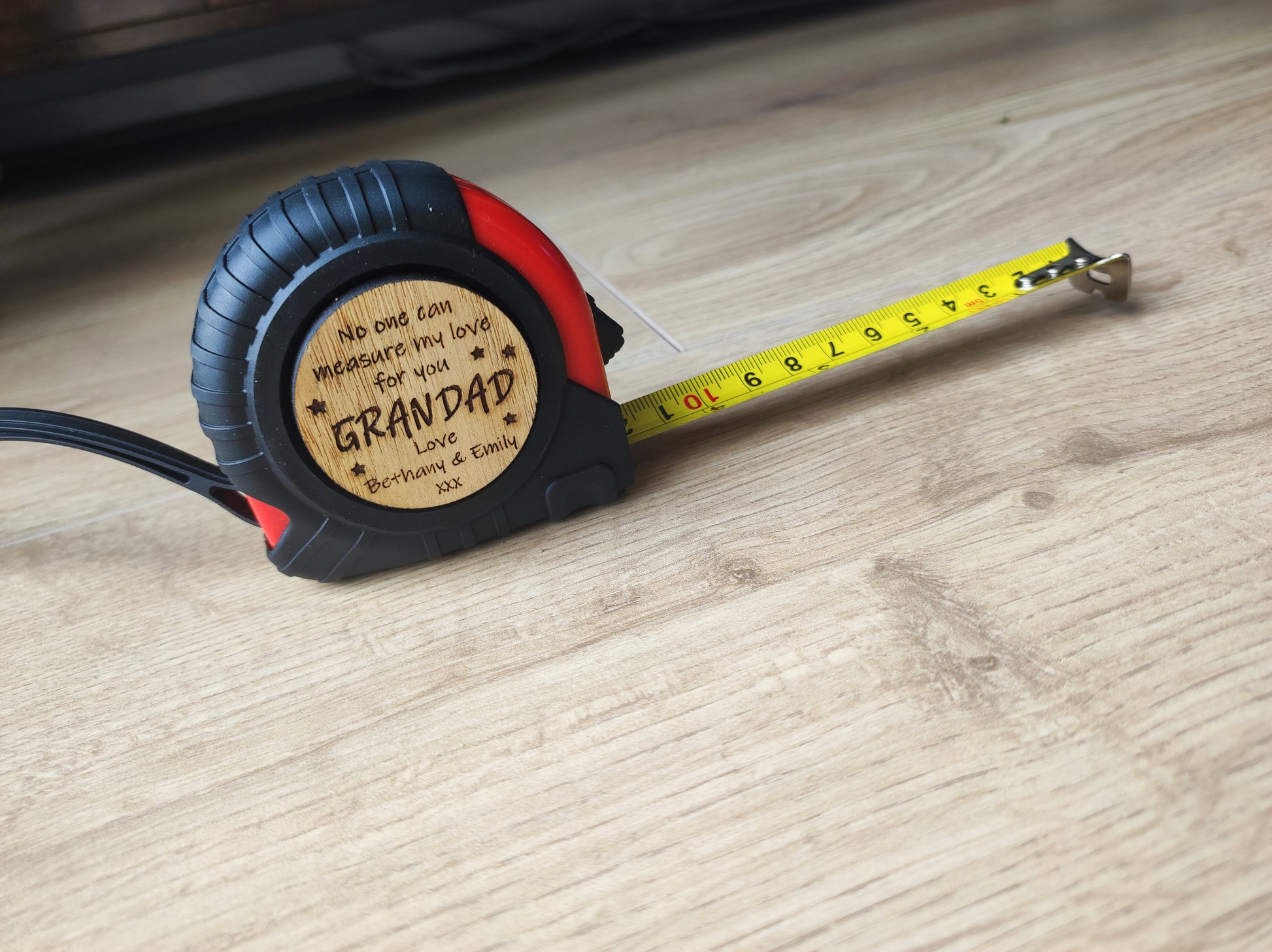 Round tape measure with a playful message: 'No one can measure my love for you.' The disc features a compact, convenient design with a retractable tape, perfect for a thoughtful and unique gift.
