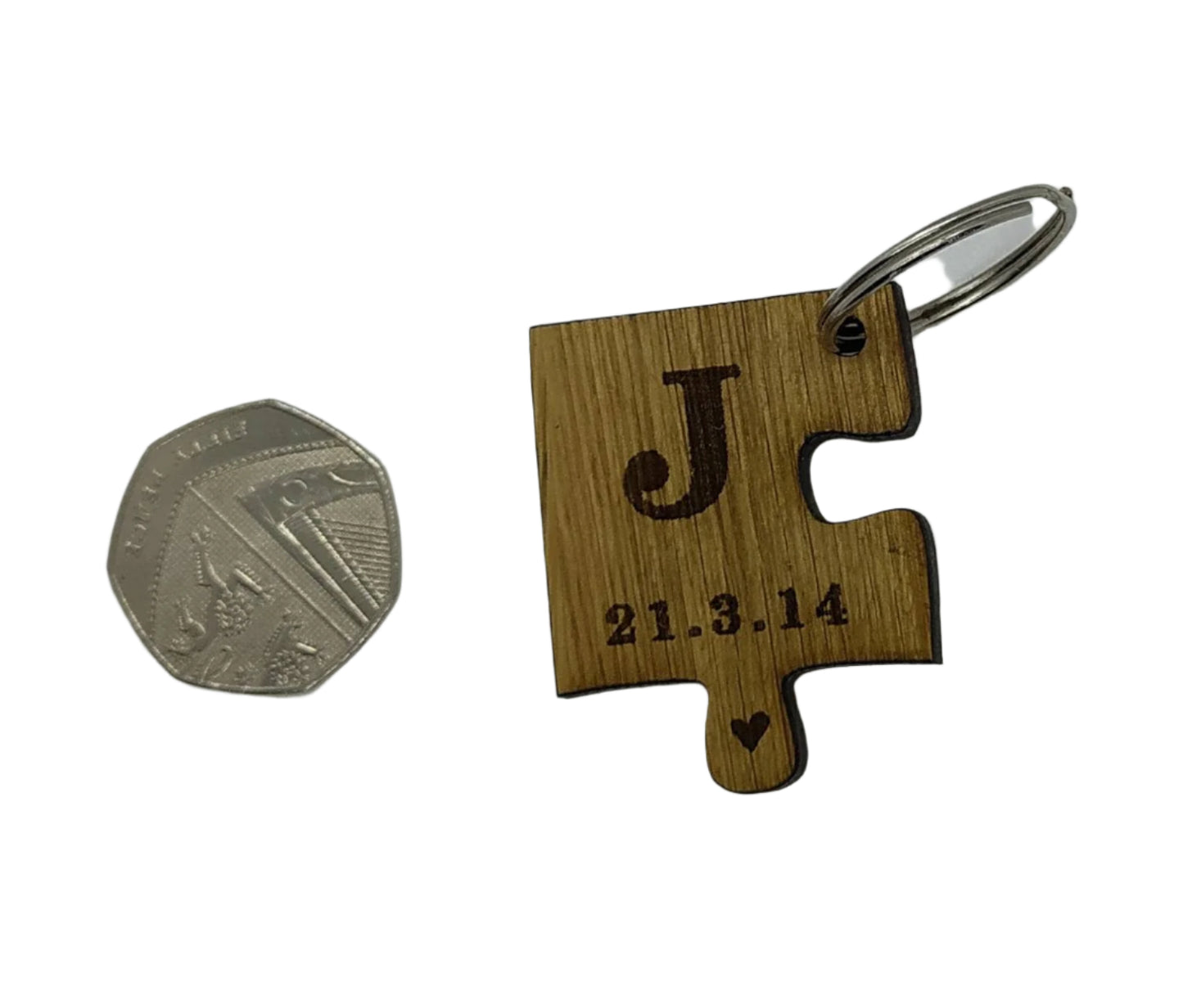 2 puzzle piece keyrings engraved with initials and a special date.