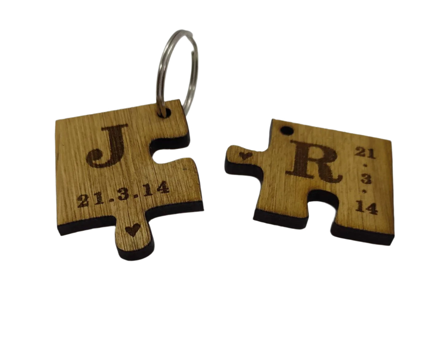 2 puzzle piece keyrings engraved with initials and a special date.