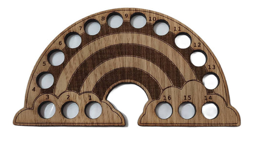 Rainbow-shaped thread holder with 16 holes for organising thread.