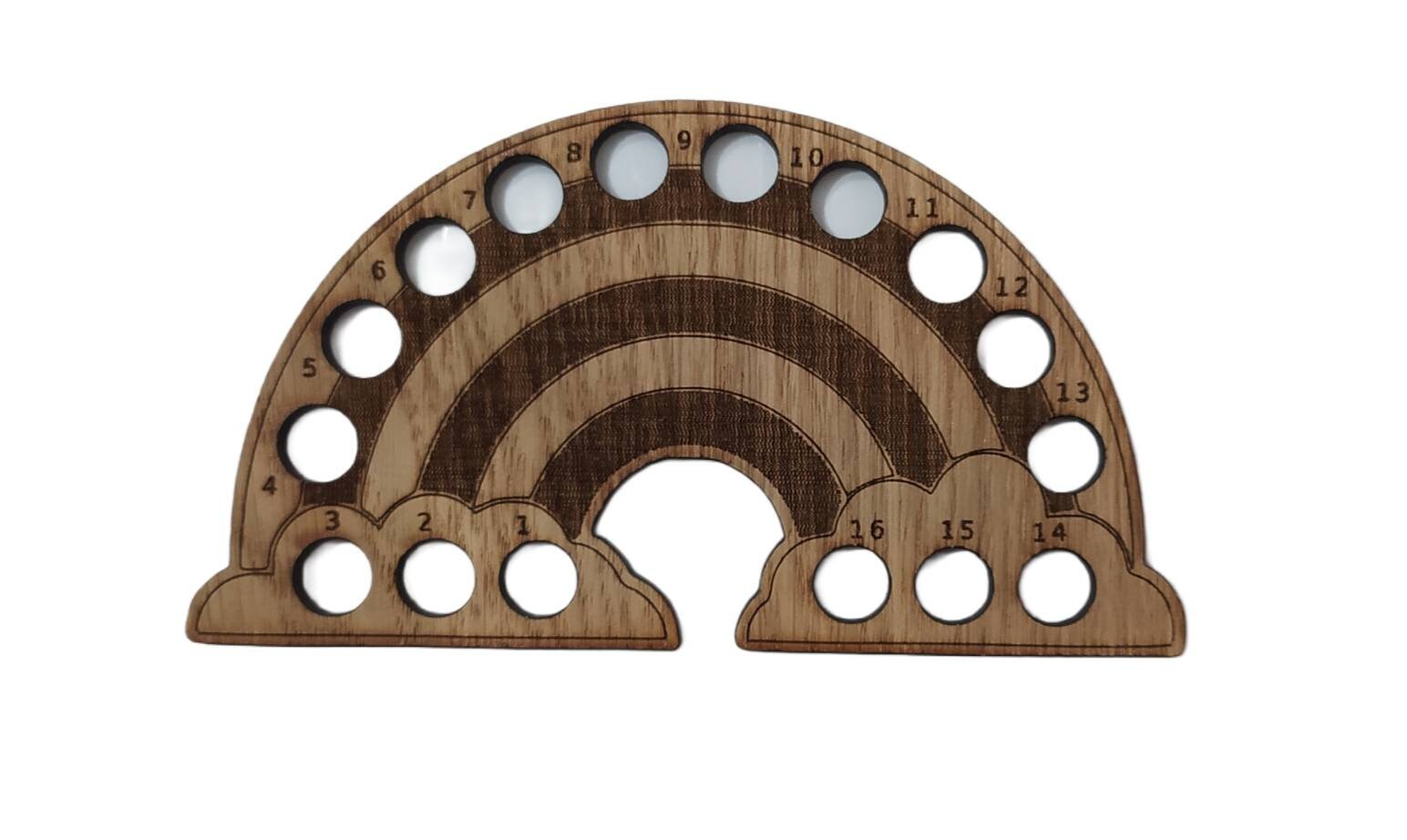 Rainbow-shaped thread holder with 16 holes for organising thread.