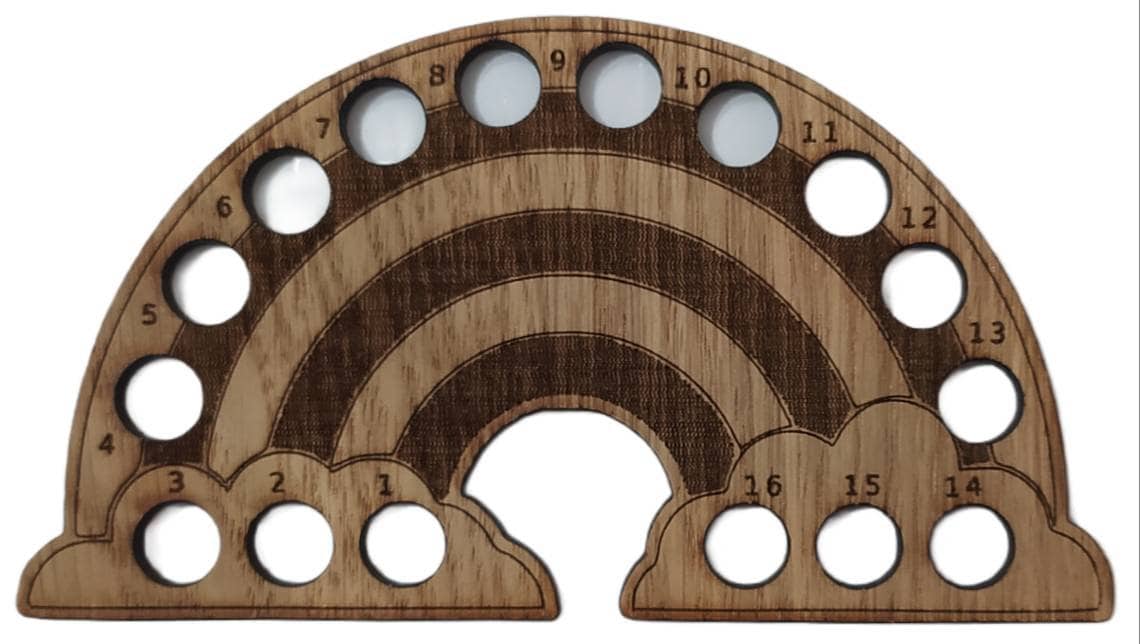 Rainbow-shaped thread holder with 16 holes for organising thread.
