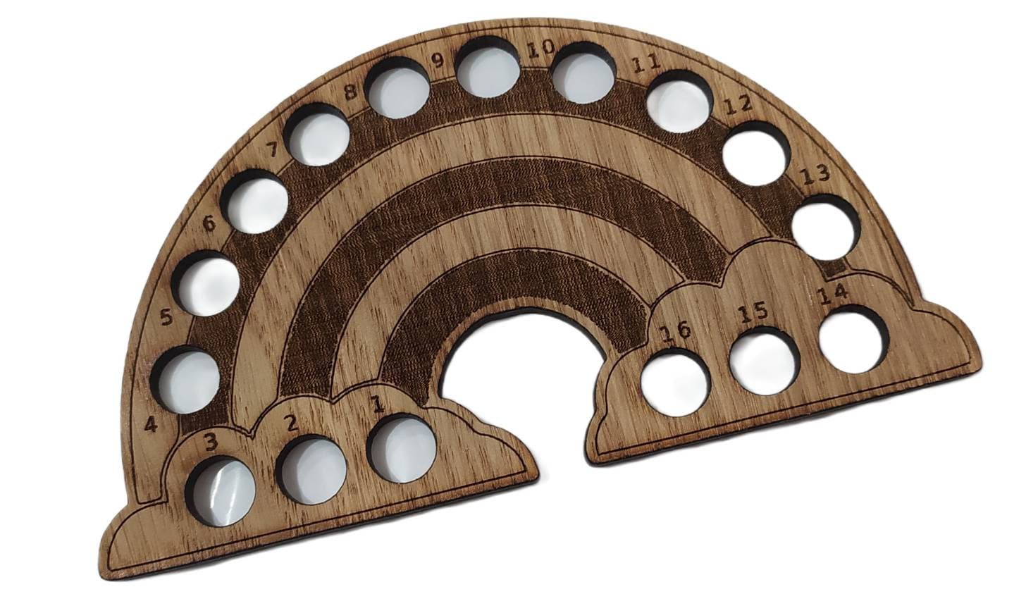 Rainbow-shaped thread holder with 16 holes for organising thread.