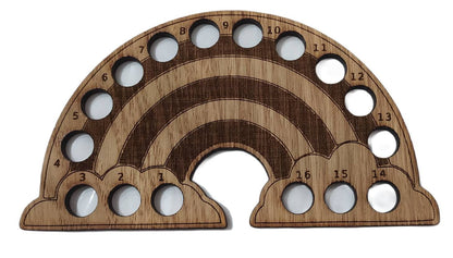 Rainbow-shaped thread holder with 16 holes for organising thread.
