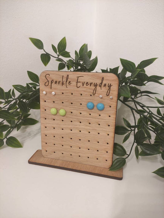Laser-engraved oak veneer earring holder with the message "Sparkle Everyday," designed to hold up to 32 pairs of stud earrings.