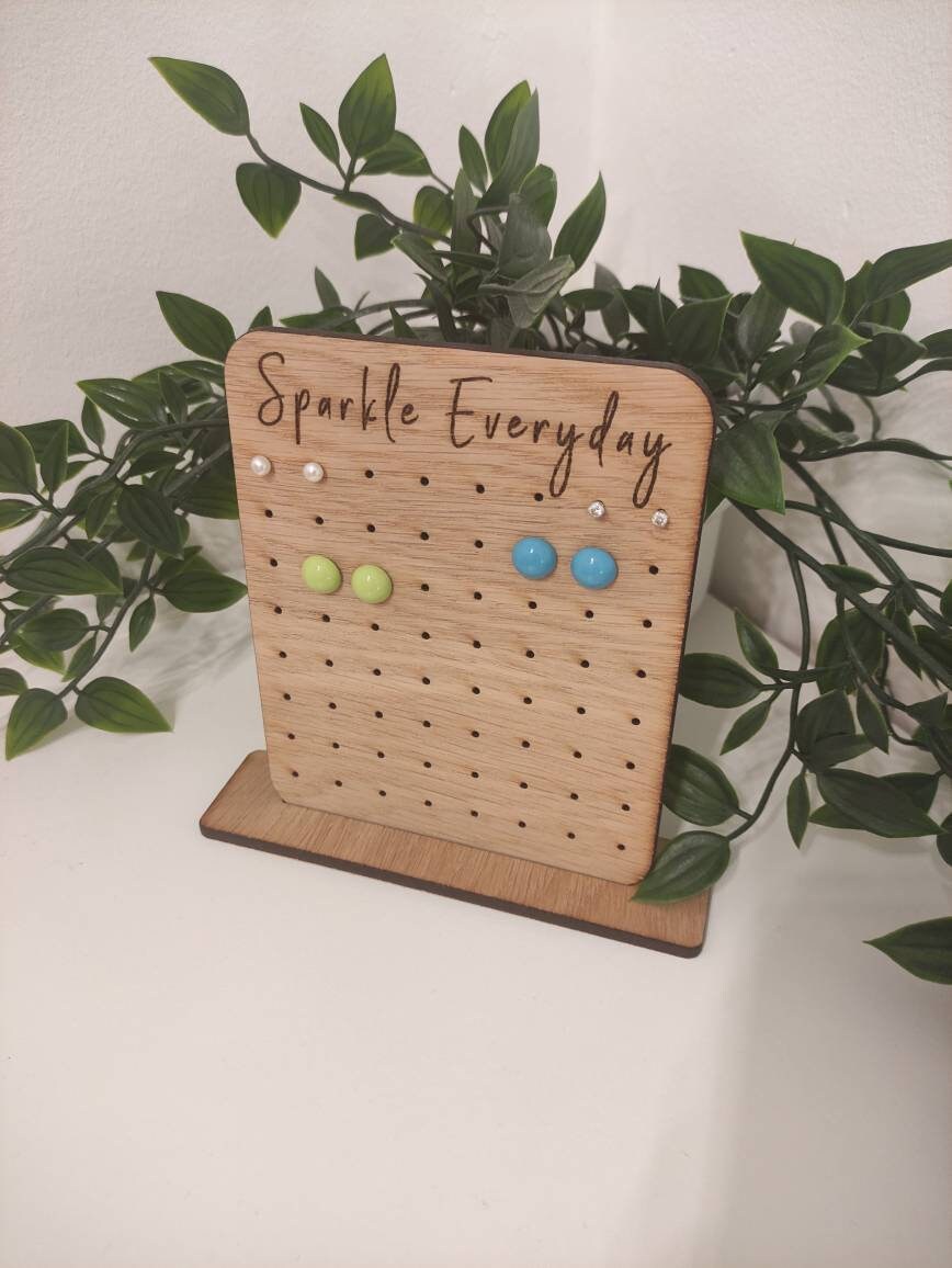 Laser-engraved oak veneer earring holder with the message "Sparkle Everyday," designed to hold up to 32 pairs of stud earrings.