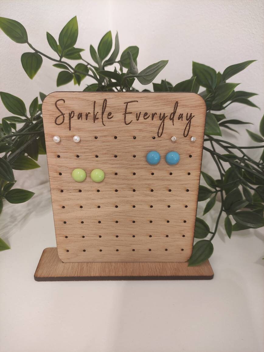 Laser-engraved oak veneer earring holder with the message "Sparkle Everyday," designed to hold up to 32 pairs of stud earrings.