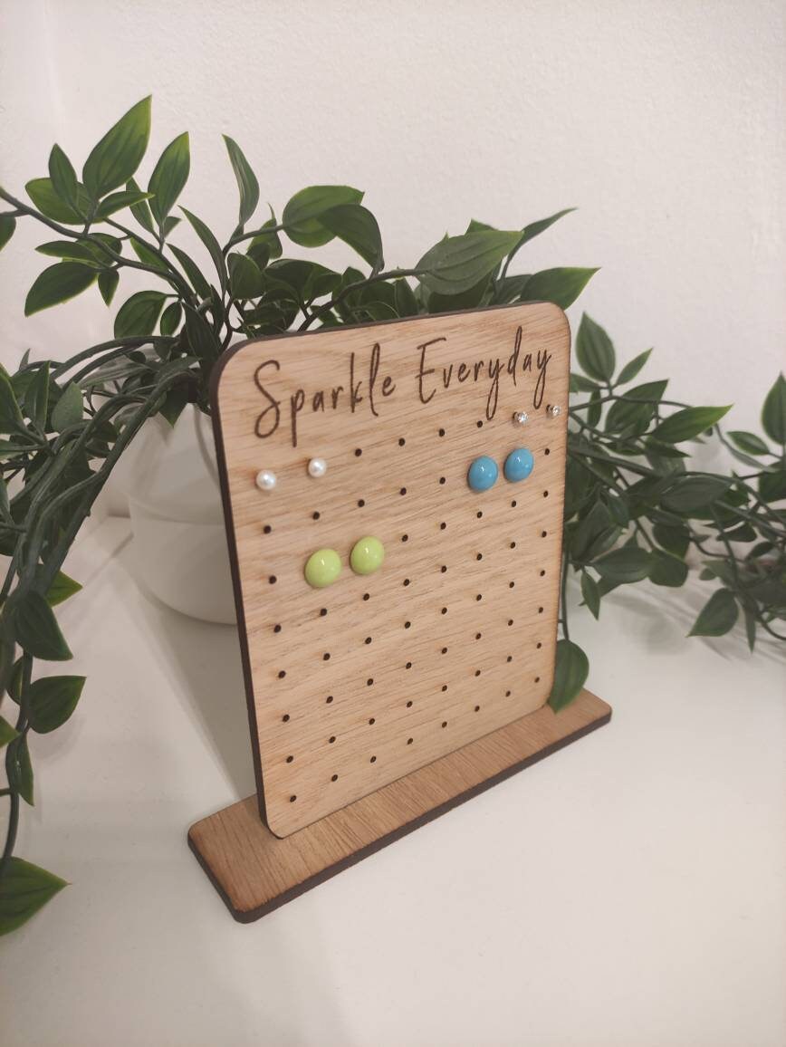 Laser-engraved oak veneer earring holder with the message "Sparkle Everyday," designed to hold up to 32 pairs of stud earrings.