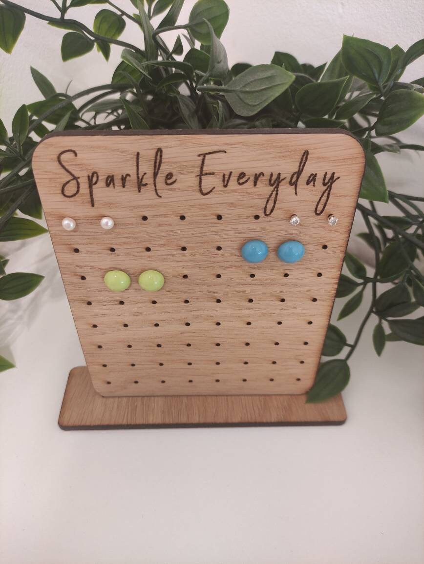 Laser-engraved oak veneer earring holder with the message "Sparkle Everyday," designed to hold up to 32 pairs of stud earrings.