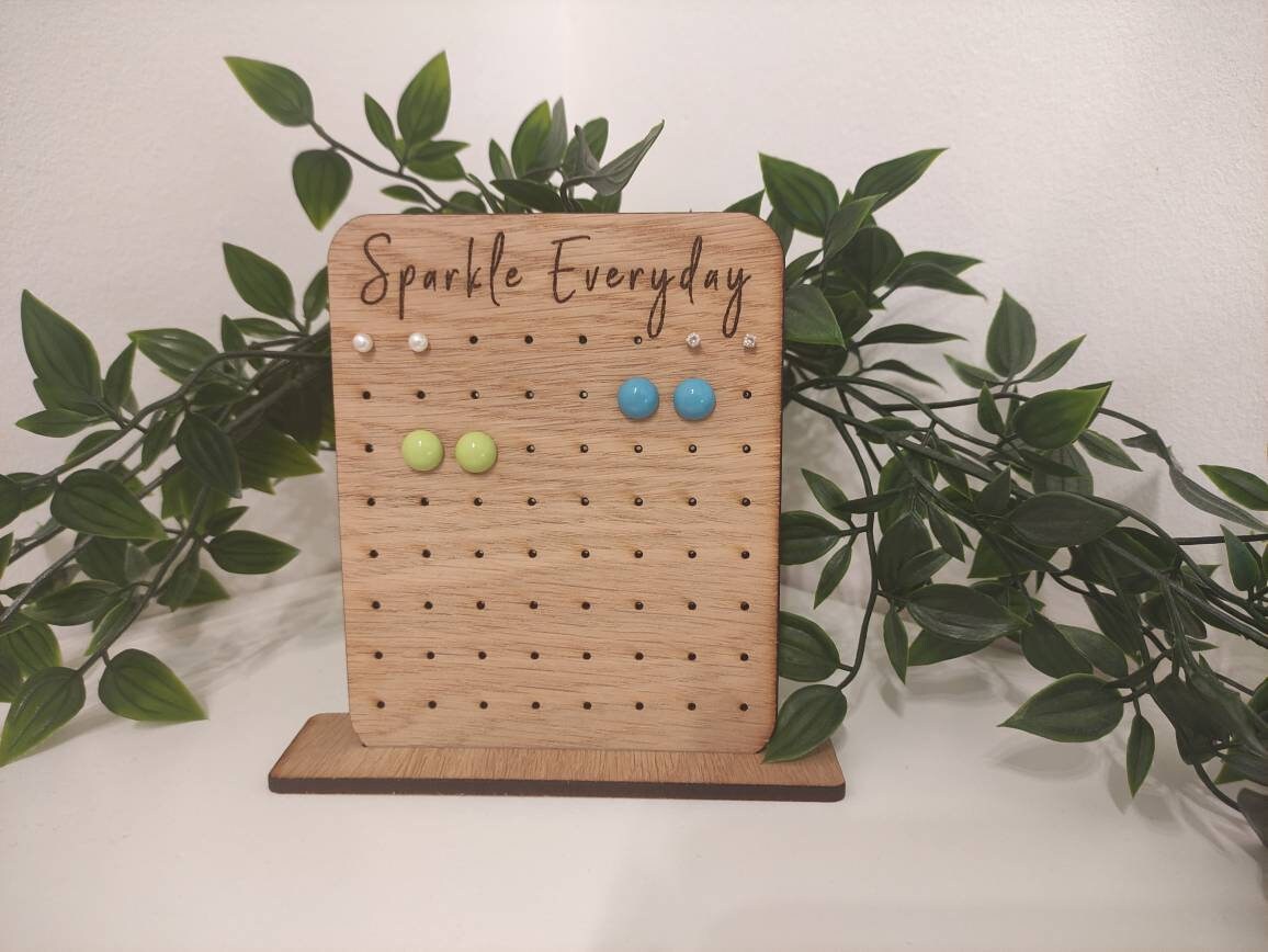 Laser-engraved oak veneer earring holder with the message "Sparkle Everyday," designed to hold up to 32 pairs of stud earrings.