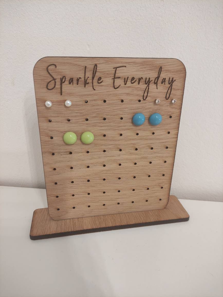 Laser-engraved oak veneer earring holder with the message "Sparkle Everyday," designed to hold up to 32 pairs of stud earrings.