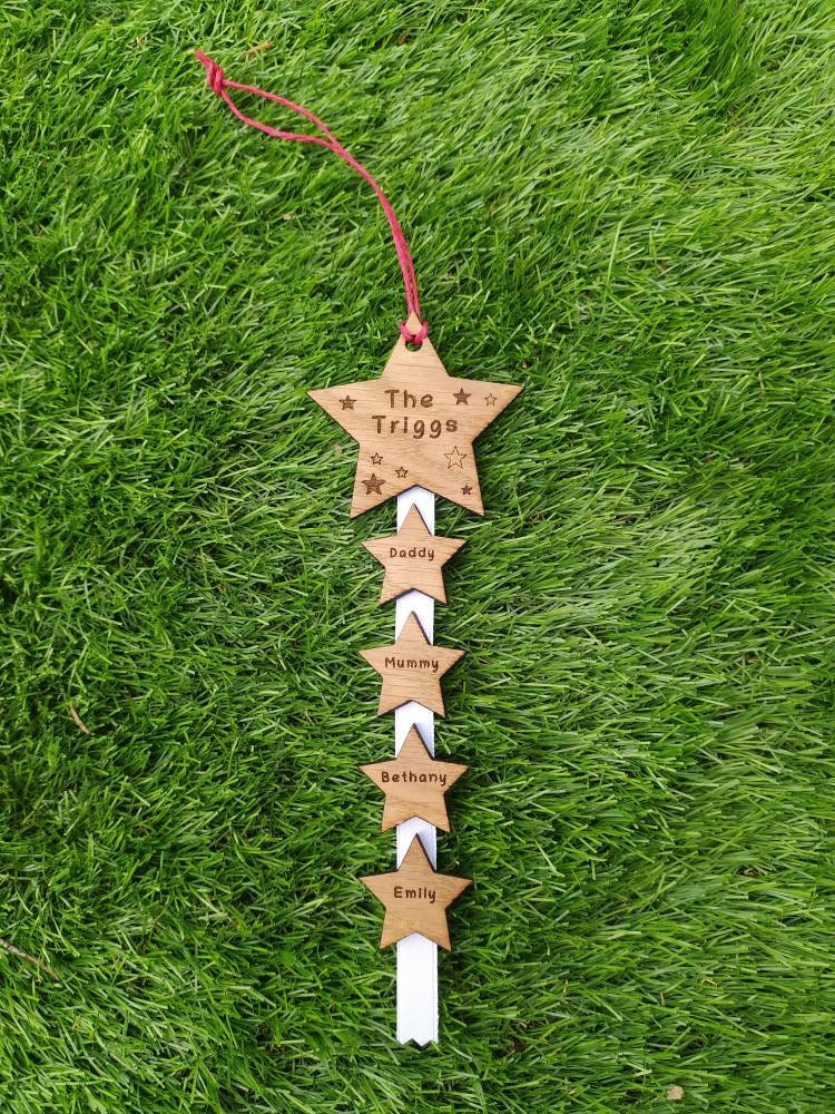 "Personalised Family Christmas Star Tree Hanger with laser-cut stars, custom engraved with family names, featuring red, white, or green hanging string."