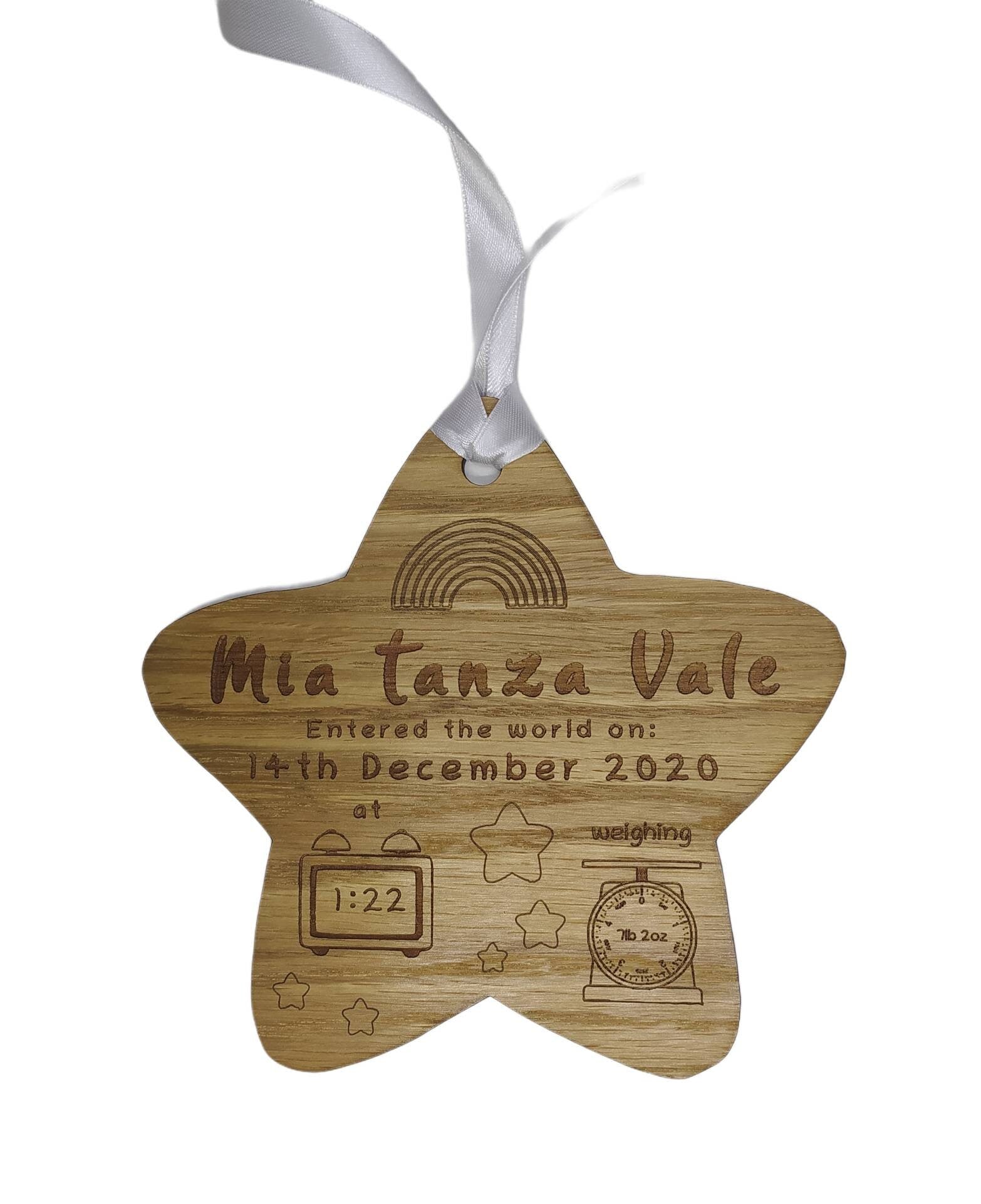 Personalised oak veneer wooden star engraved with a newborn's full name, date of birth, time, and weight. Finished with a white string for hanging, making it a thoughtful keepsake for families.