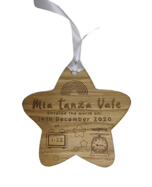 Personalised oak veneer wooden star engraved with a newborn's full name, date of birth, time, and weight. Finished with a white string for hanging, making it a thoughtful keepsake for families.