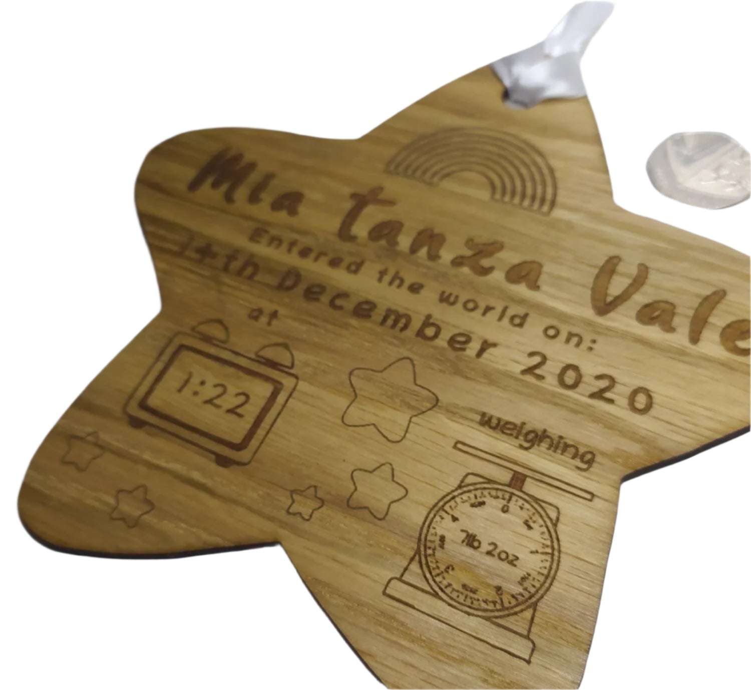 Personalised oak veneer wooden star engraved with a newborn's full name, date of birth, time, and weight. Finished with a white string for hanging, making it a thoughtful keepsake for families.