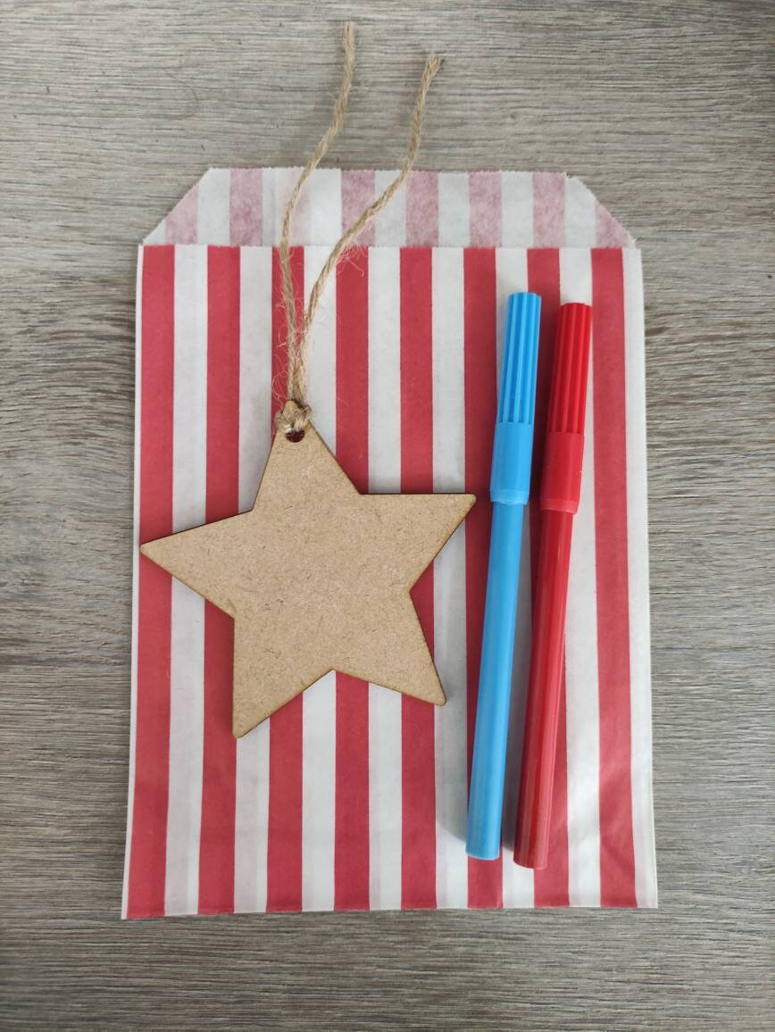 Wooden laser-cut shape with a hole at the top for hanging, string included, and 2 coloured pens inside a paper bag.