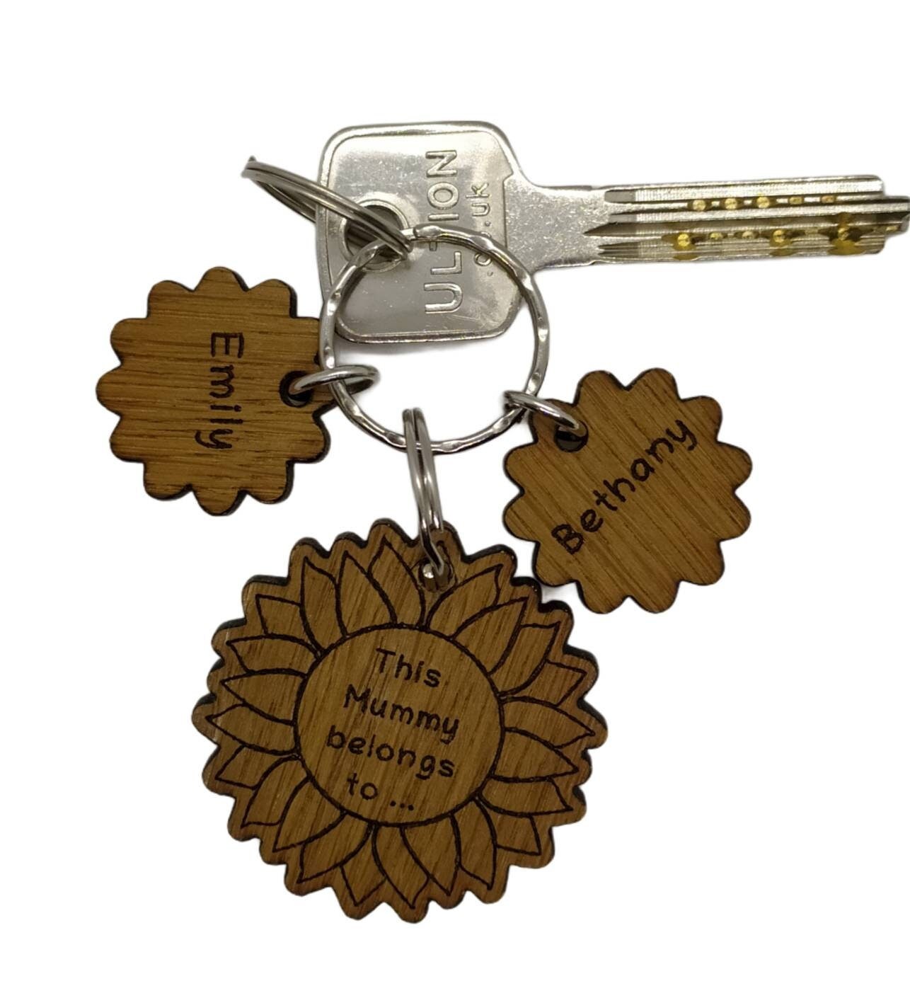 Sunflower-style keyring engraved with "This (any name) belongs to..." and customisable with additional charms.