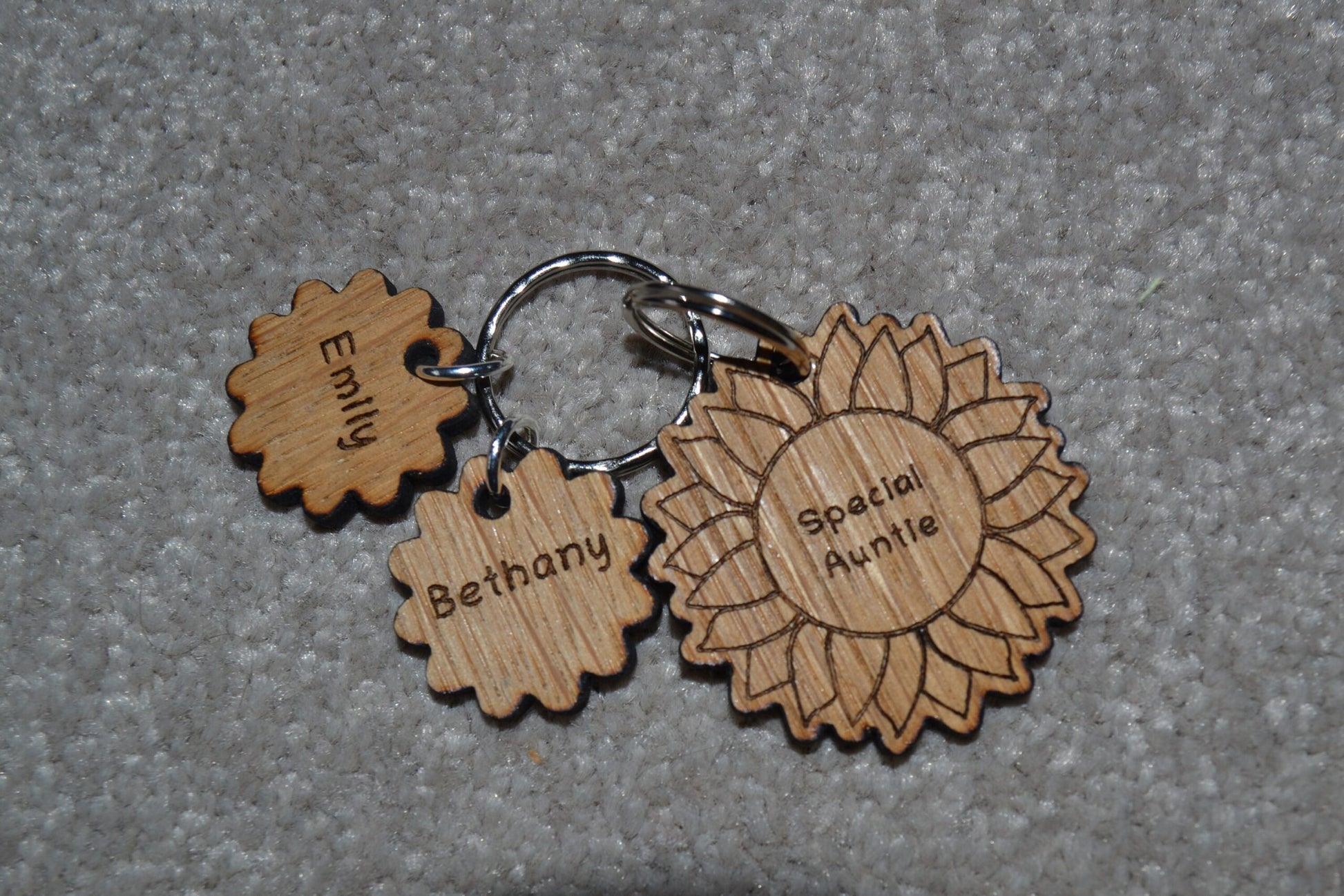 Sunflower-style keyring engraved with "This (any name) belongs to..." and customisable with additional charms.