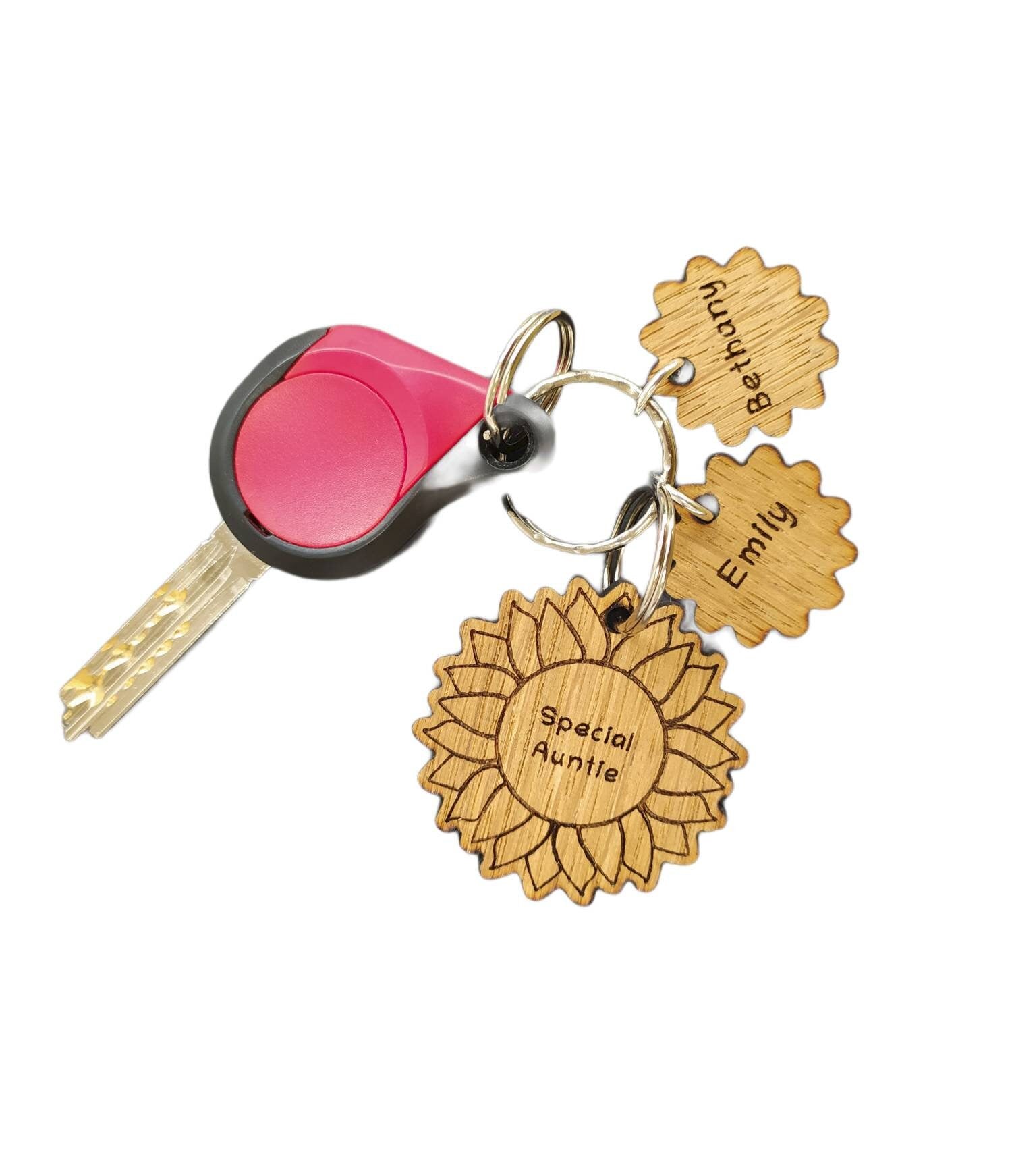 Sunflower-style keyring engraved with "This (any name) belongs to..." and customisable with additional charms.