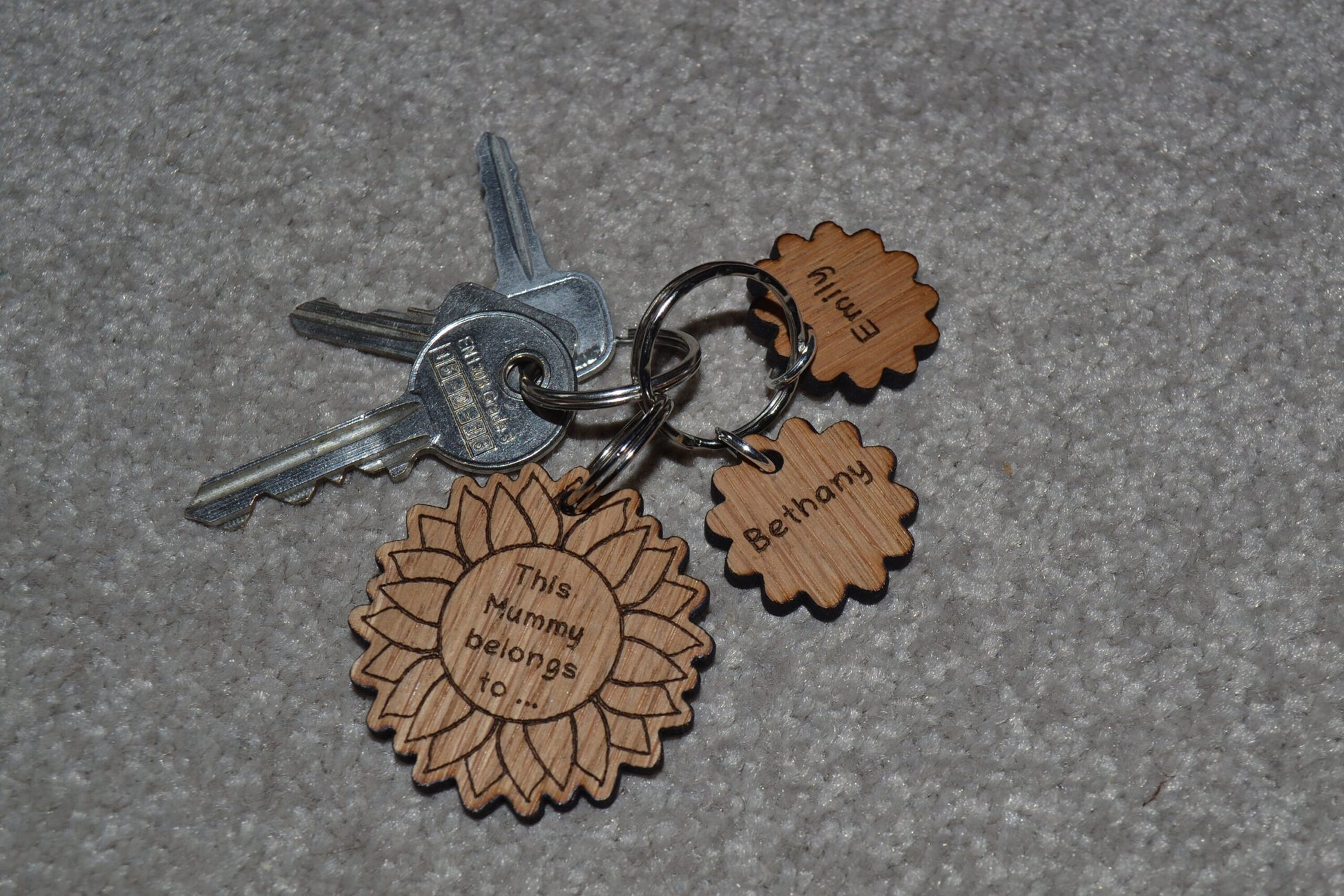 Sunflower-style keyring engraved with "This (any name) belongs to..." and customisable with additional charms.