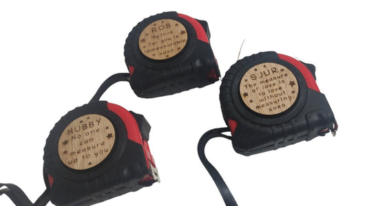 Personalised tape measure with a wooden disc, custom engraved names with your chosen message. This unique, functional gift combines practicality with a fun, stylish touch.