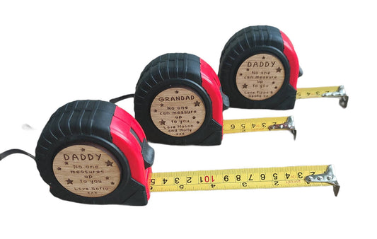Personalised tape measure with a wooden disc, custom engraved names with your chosen message. This unique, functional gift combines practicality with a fun, stylish touch.
