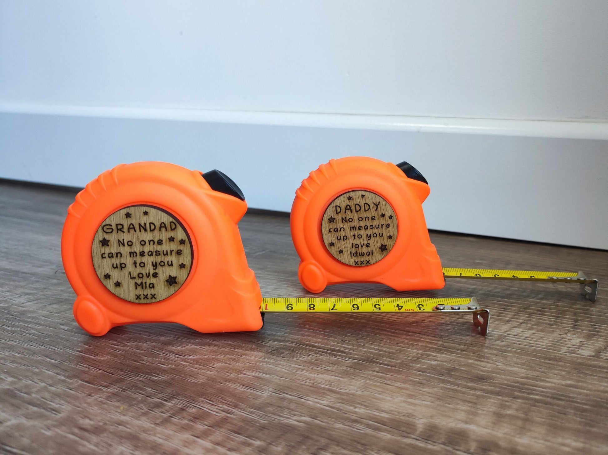 Personalised tape measure with a wooden disc, custom engraved names with your chosen message. This unique, functional gift combines practicality with a fun, stylish touch.