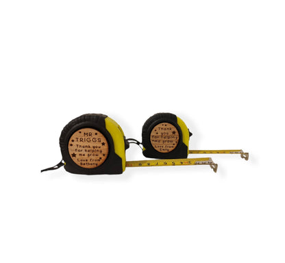 Personalised tape measure with a wooden disc, custom engraved names with your chosen message. This unique, functional gift combines practicality with a fun, stylish touch.