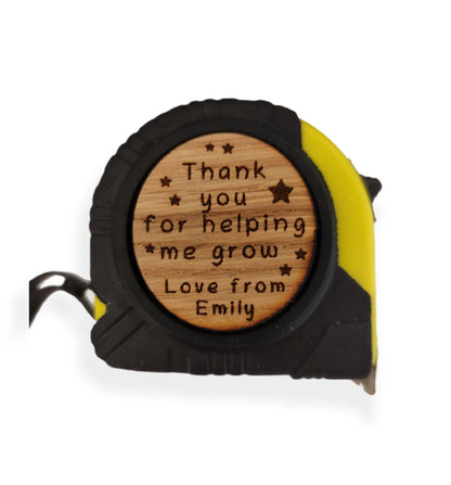 Personalised tape measure with a wooden disc, custom engraved names with your chosen message. This unique, functional gift combines practicality with a fun, stylish touch.